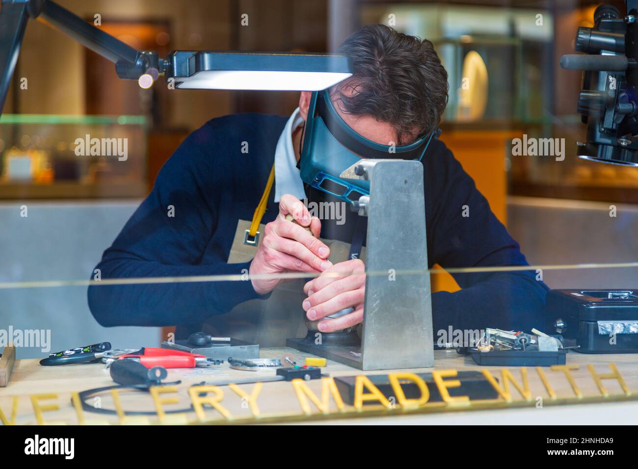 Jeweller carrying out repairs, london, uk Stock Photo