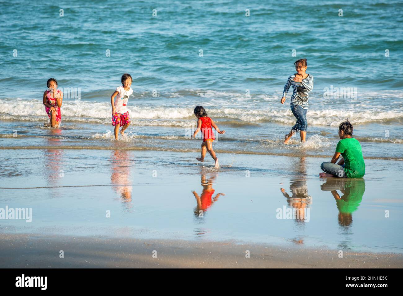 Happy asian family playing at the beach hi-res stock photography and ...