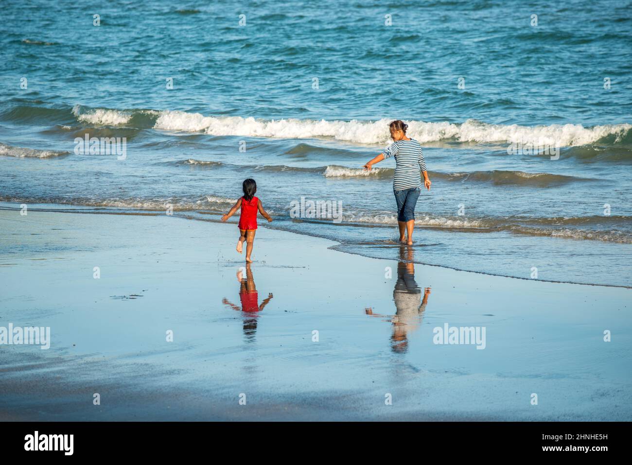 Happy asian family playing at the beach hi-res stock photography and ...