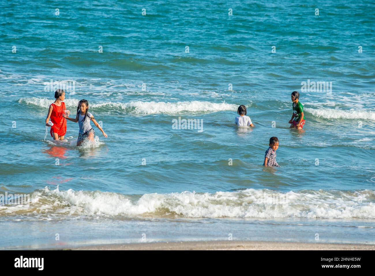 Happy asian family playing at the beach hi-res stock photography and ...