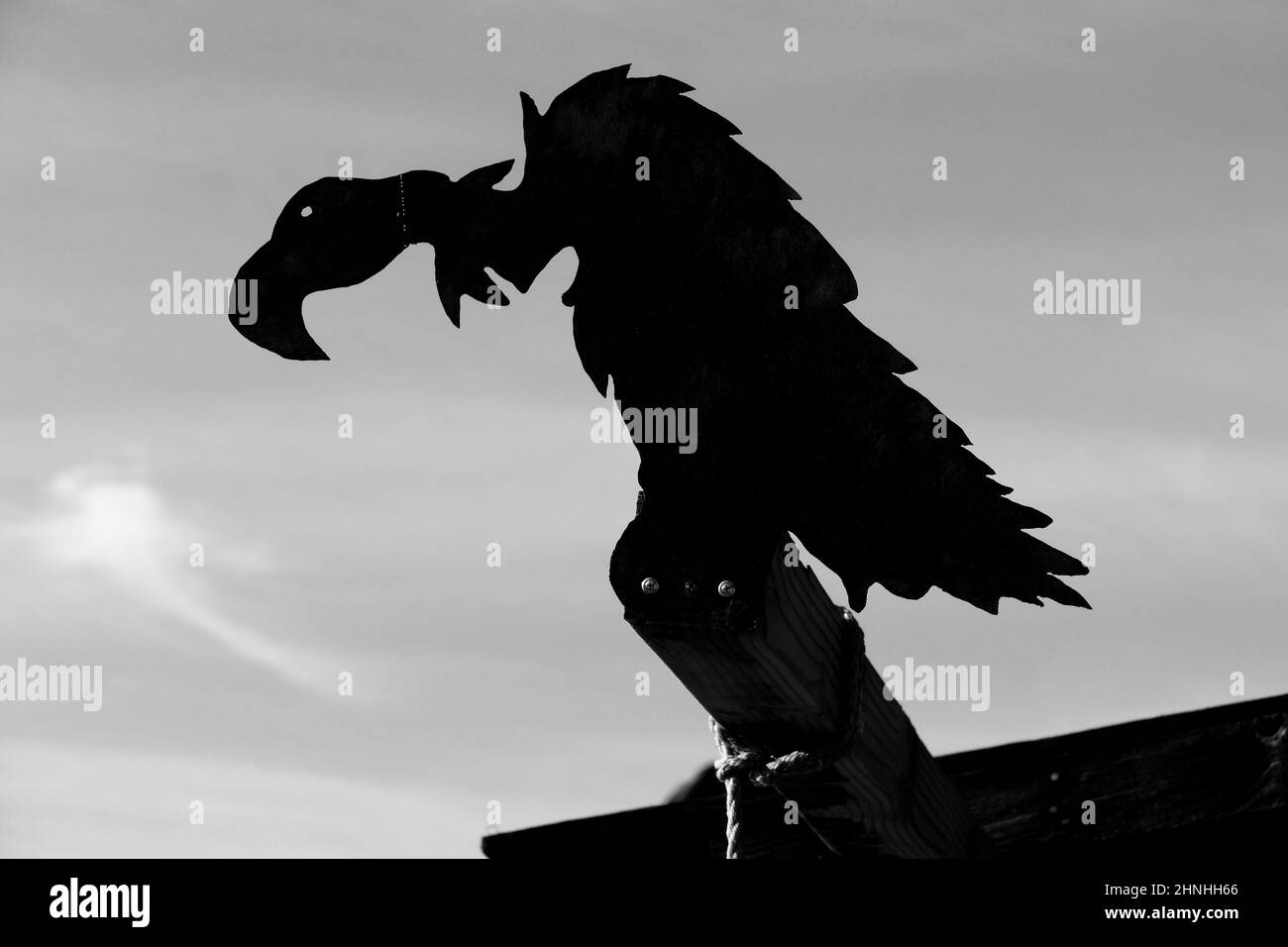 Monochrome silhouette of a vulture on a gallows in the Wild West ghost town of Calico, San Bernardino County, California, USA Stock Photo