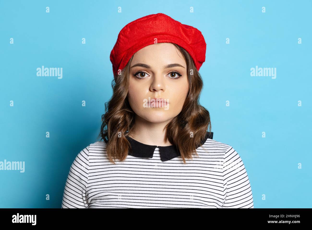 Halflength portrait of young charming girl with long curly hair