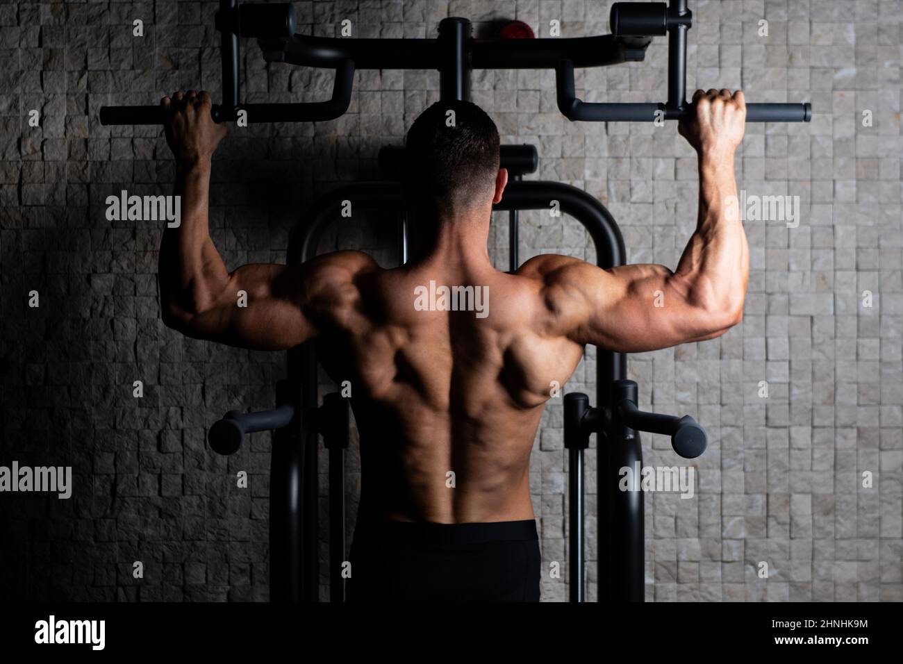 Male Athlete Doing Pull Ups Stock Photo