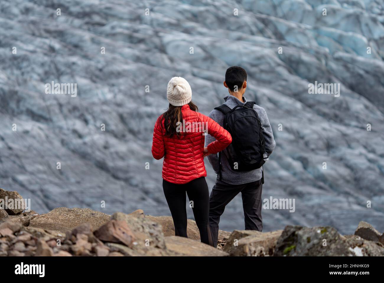 Unrecognizable tourist couple looking to the glacier Stock Photo