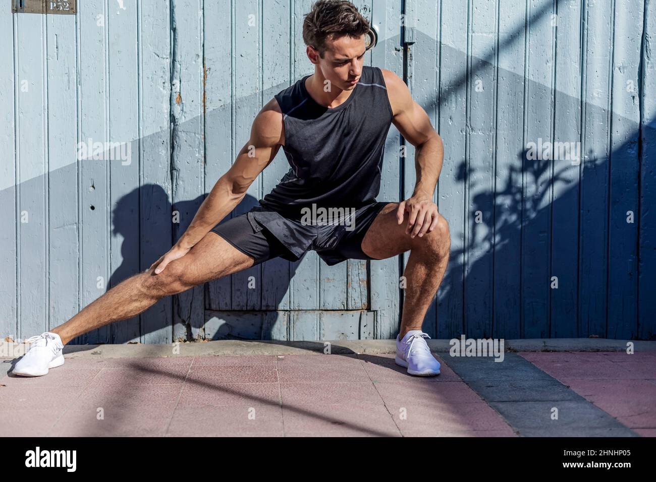 Man jogger stretching legs doing hi-res stock photography and images ...