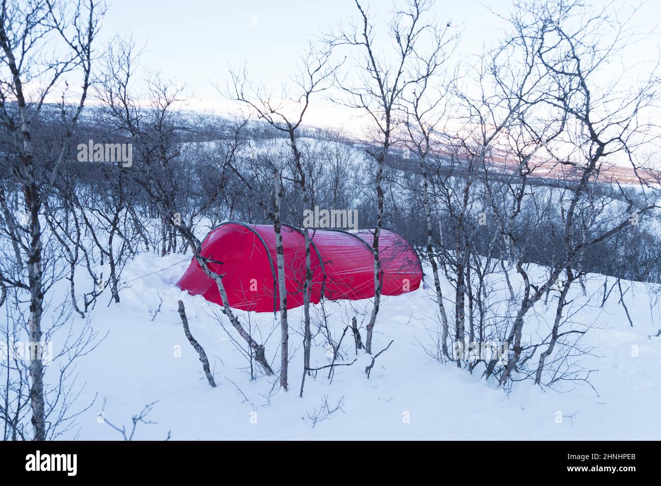 small red tent in the snow in swedish lapland Stock Photo