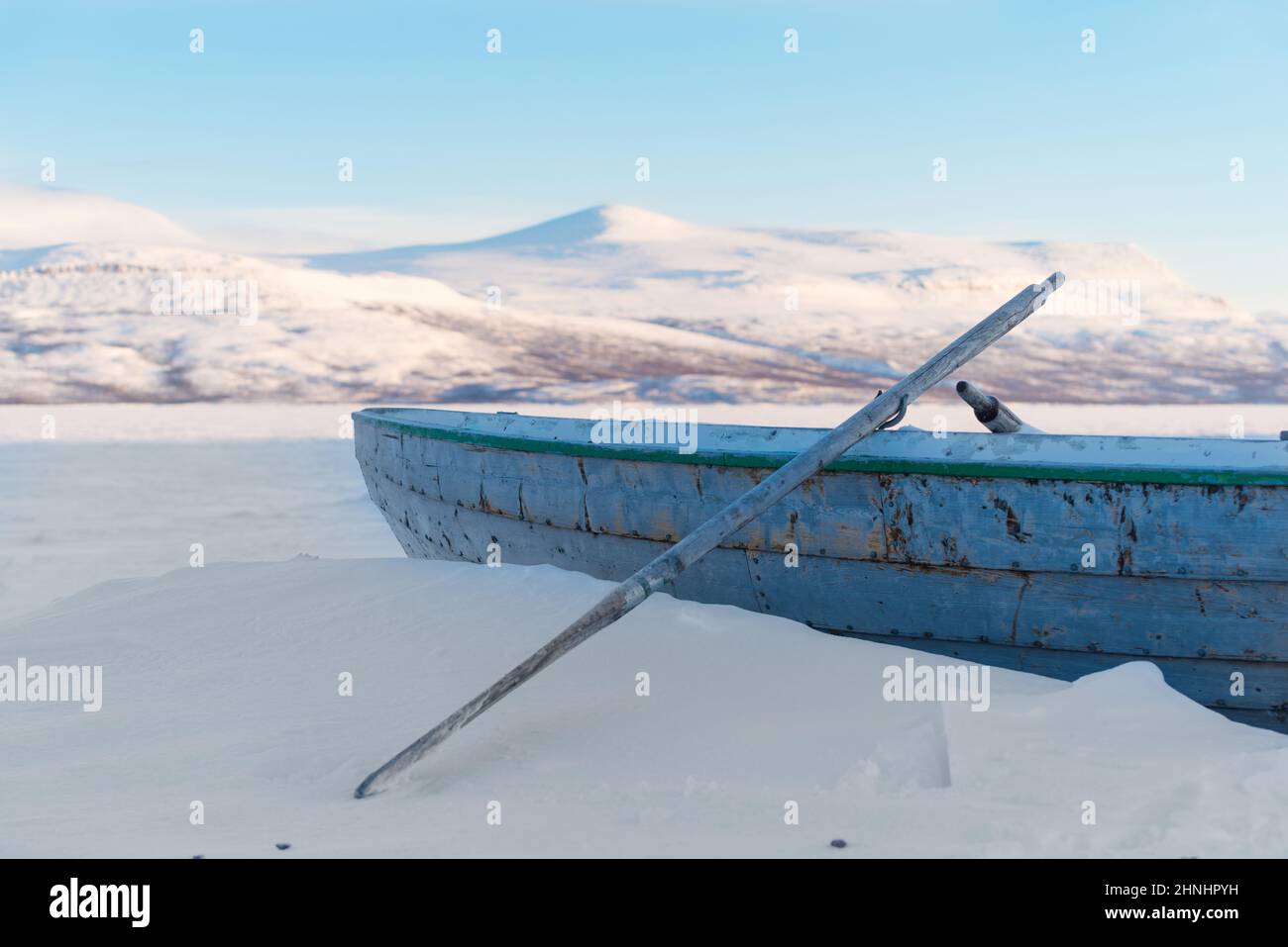 rowing boat on a frozen lake in the northern part of Sweden Stock Photo