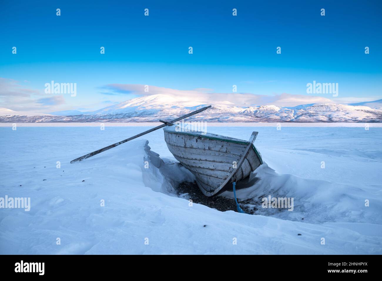 rowing boat on a frozen lake in the northern part of Sweden Stock Photo