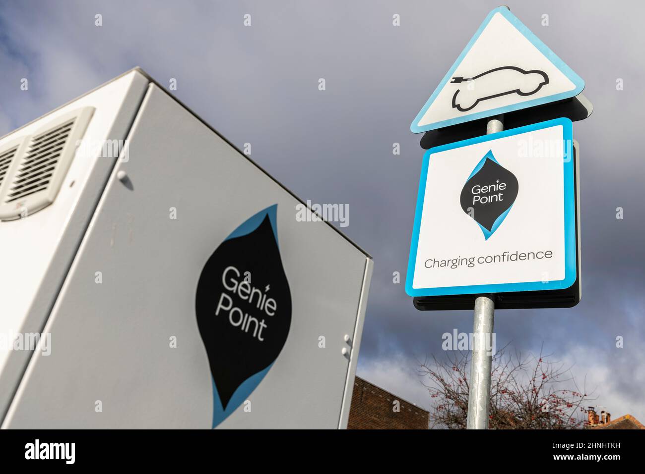 Middle aged lady using 'GeniePoint EV Charging' vehicle charging point in Hampshire , England, United Kingdom Stock Photo