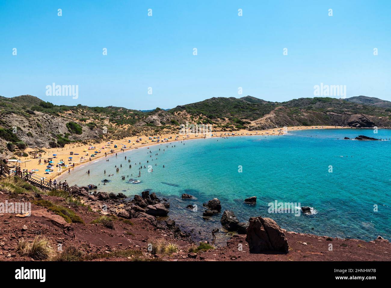 Overview of the Cavalleria beach with people around in Menorca, Balearic island, Spain Stock Photo