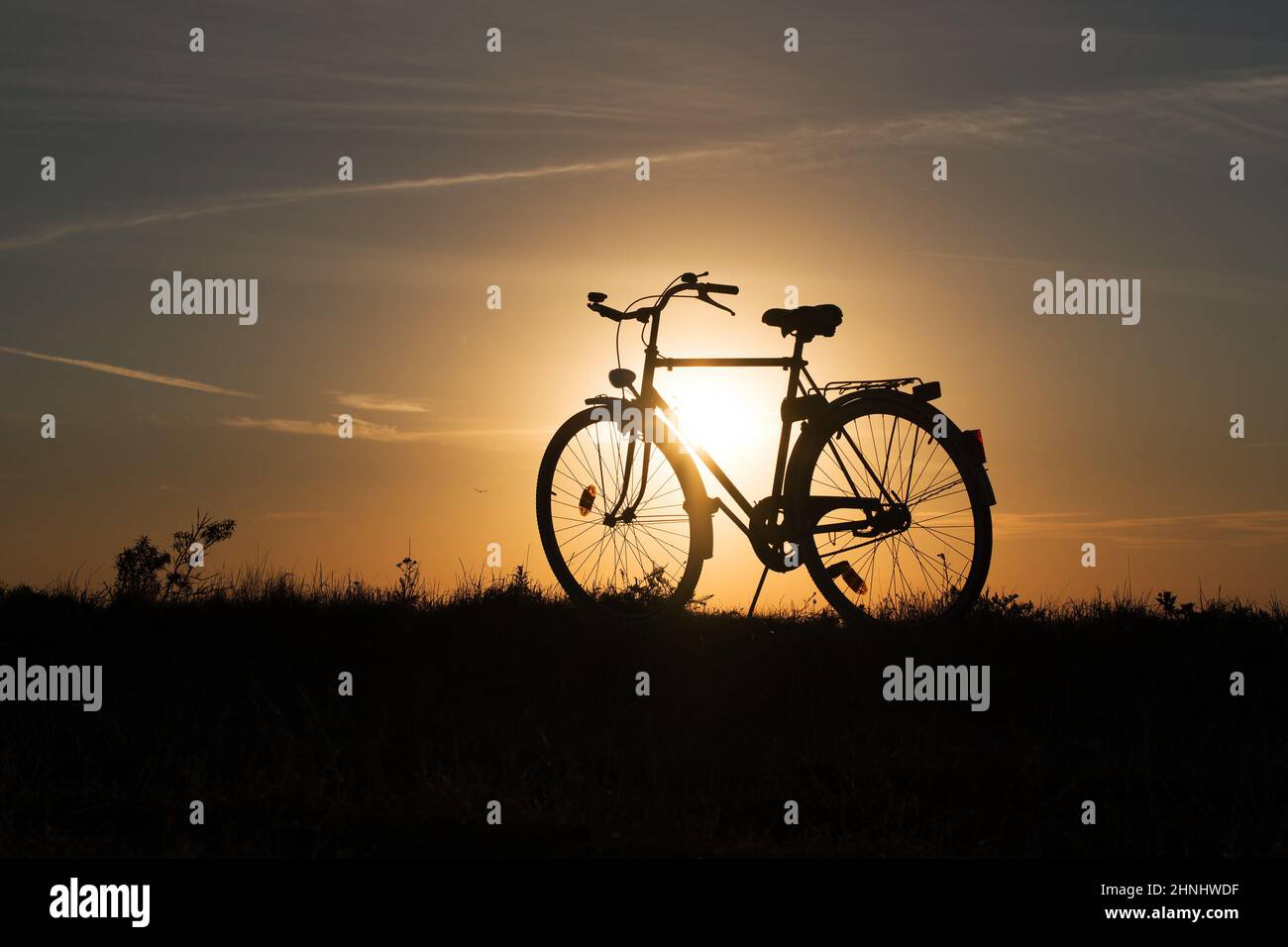 silhouette bicycle in sunset. Baltic Sea, Poland. Stock Photo