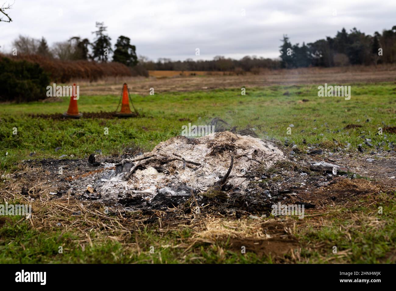 Smoking remains of a bonfire disposing of garden waste and materials