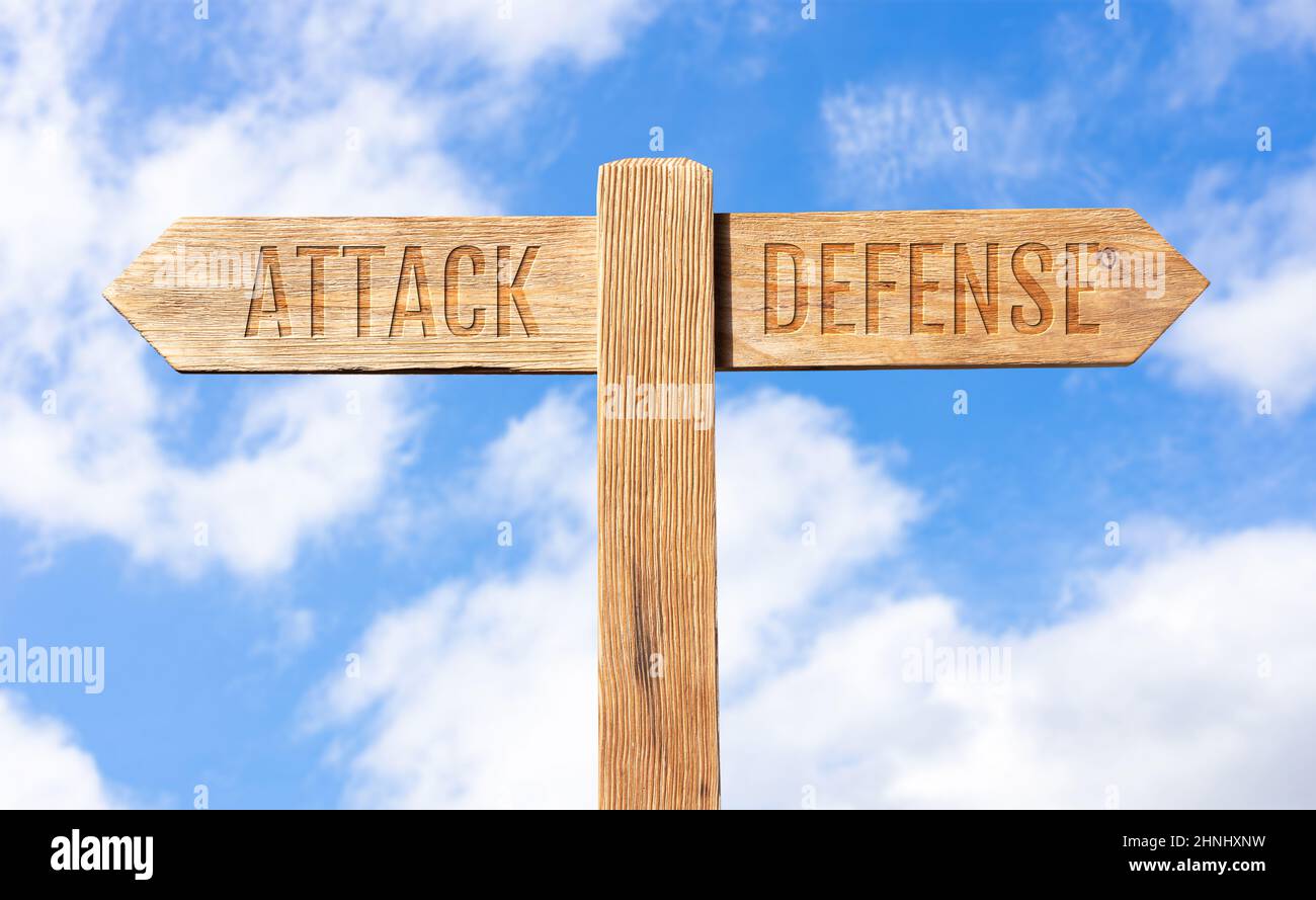 Attack defense concept. Wooden signpost with message on sky background Stock Photo