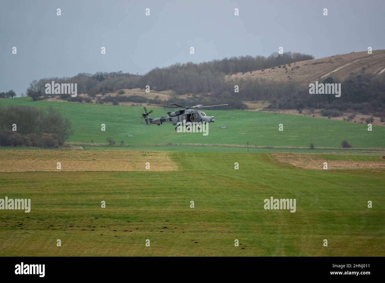 British army AgustaWestland AW159 Wildcat AH1 helicopter flying on training exercises, Wiltshire UK Stock Photo