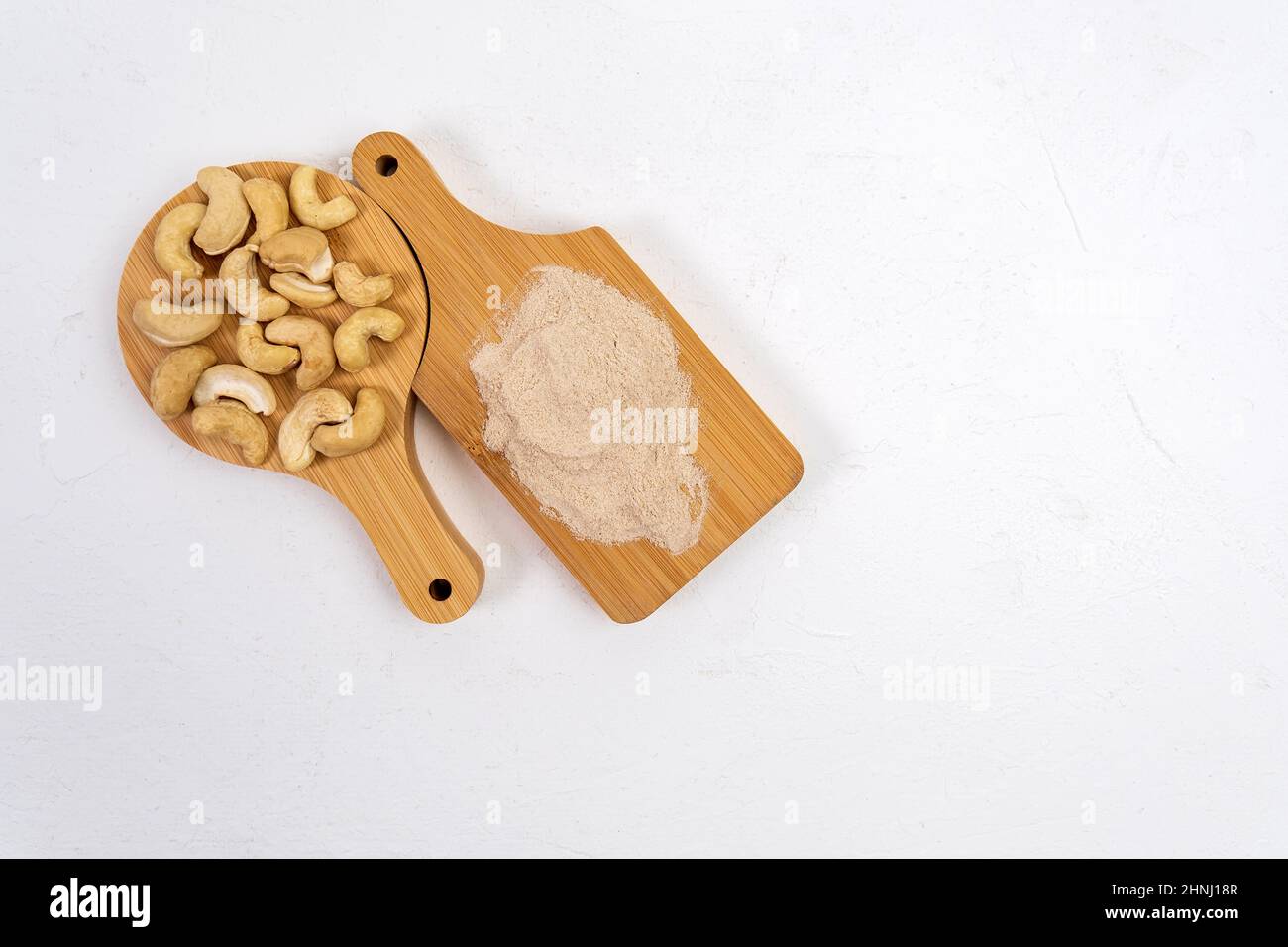 Alternative cashews flour. Grated crushed cashews, white background