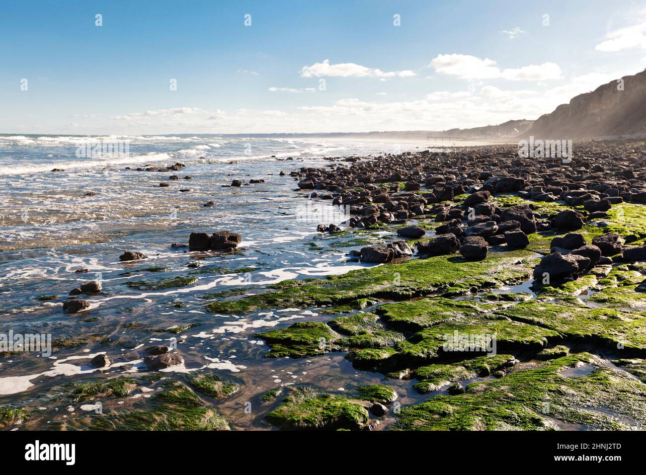 Deserted rocky beach in the morning light at Omaha Beach, Normandy, France Stock Photo