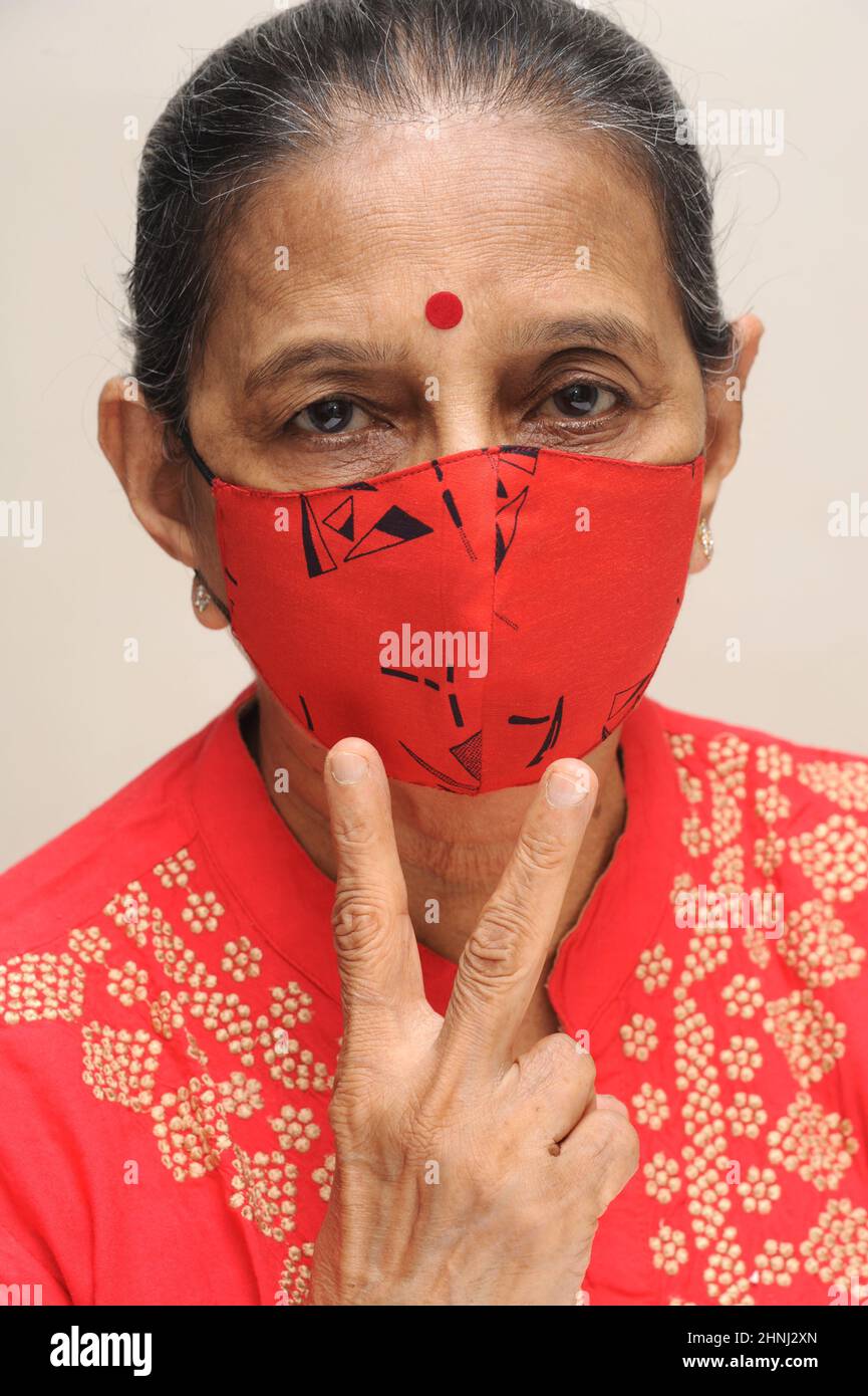 Scared, worry and face of Indian woman on pink background with