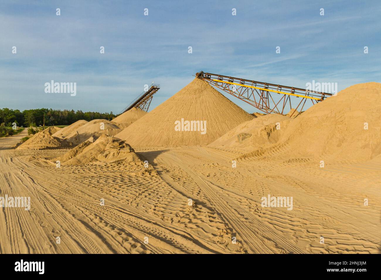 Mountains of sand and gravel and conveyor belts in a gravel pit. Pomerania, Poland Stock Photo
