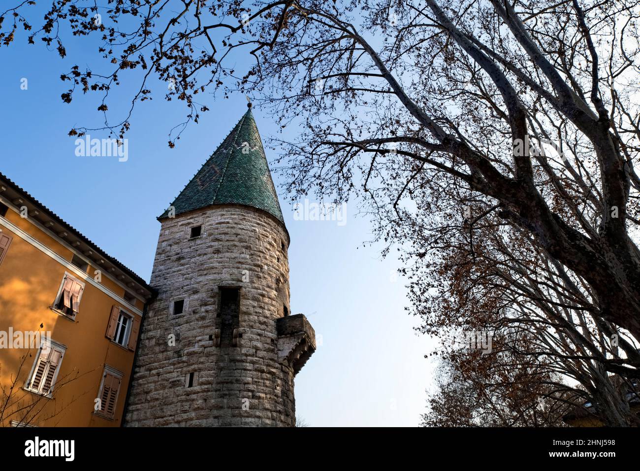 Trento: the Verde Tower is a medieval Gothic monument and takes its name from the color of its spire. Trentino Alto-Adige, Italy, Europe. Stock Photo