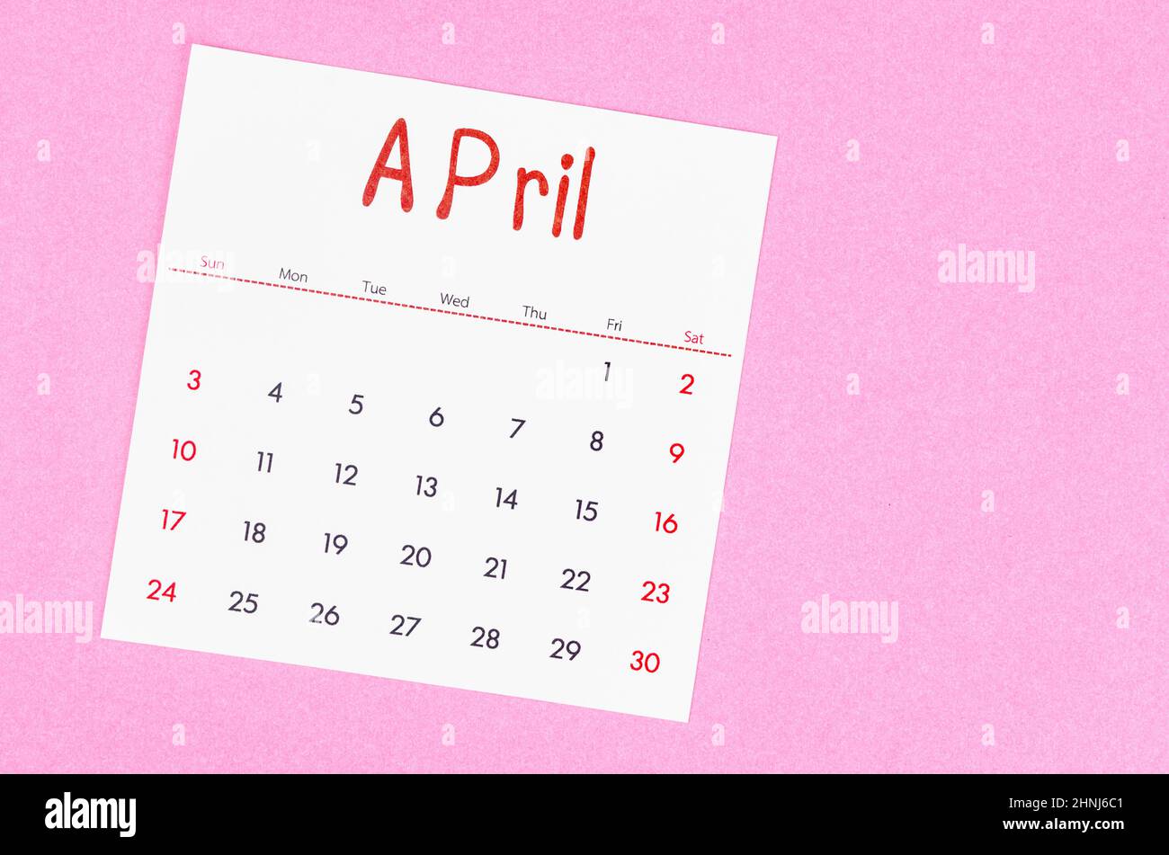 The April 2022 calendar on pink background with empty space. Stock Photo