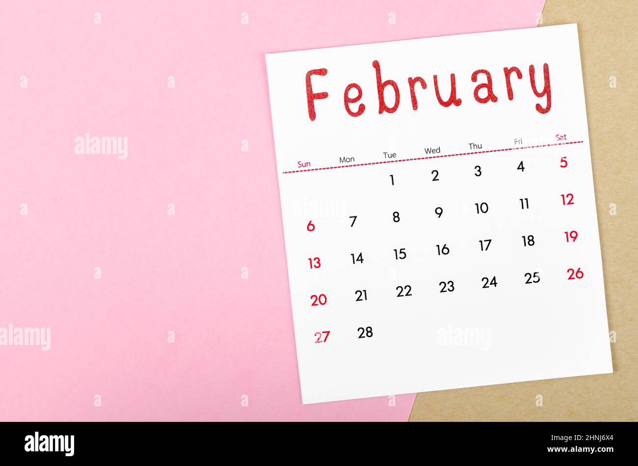 The February 2022 calendar on pink background with empty space. Stock Photo