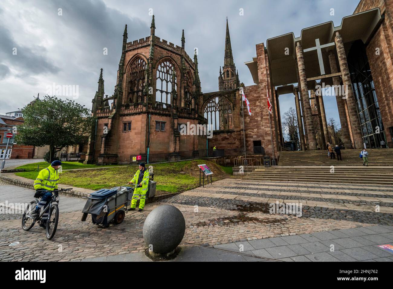 London, UK. 17th Feb, 2022. A street cleaner at work outside the ruins of the old Cathedral and the new one - Coventry is UK City of Culture and has been flagged negatively inb a speech by Keir Starmer, Labour Leader. Credit: Guy Bell/Alamy Live News Stock Photo