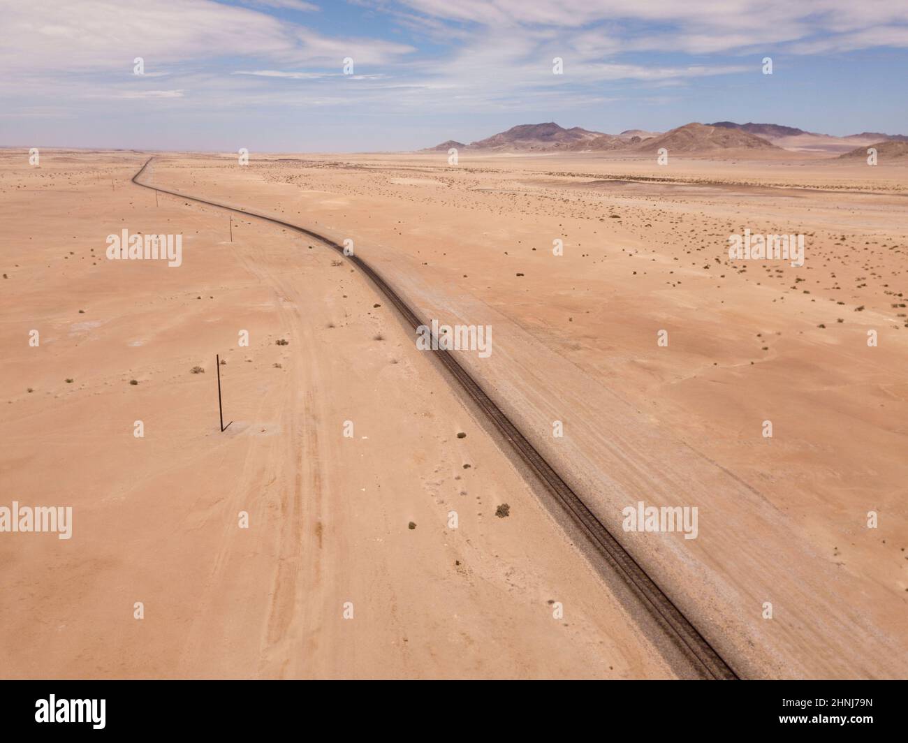 Aerial over railway tracks runnning through the desert Stock Photo