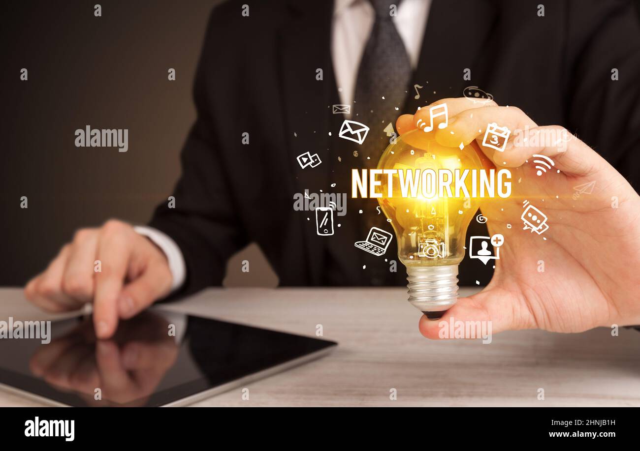 Businessman holding a light bulb, social media concept Stock Photo - Alamy