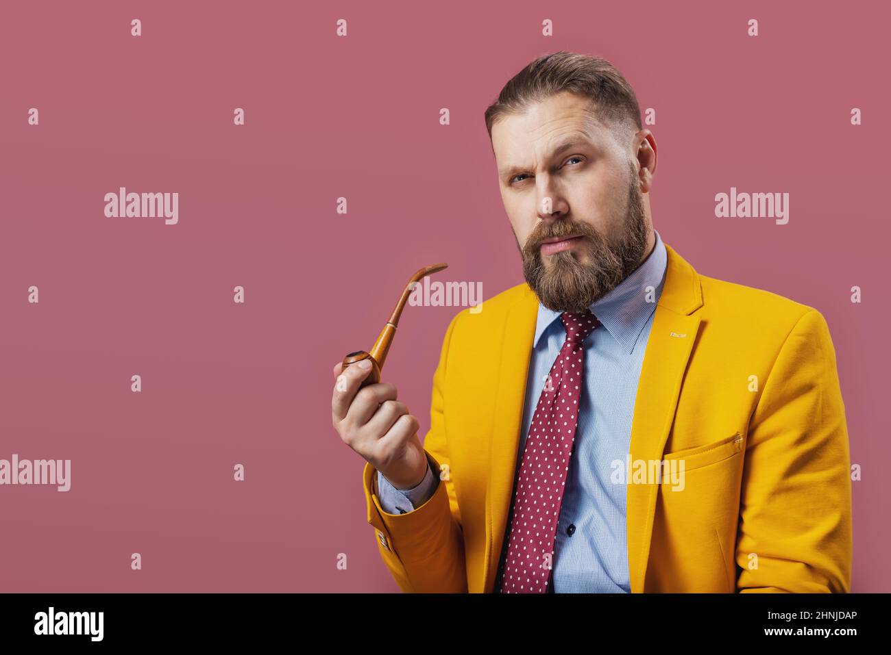 Serious man smoking pipe Stock Photo - Alamy