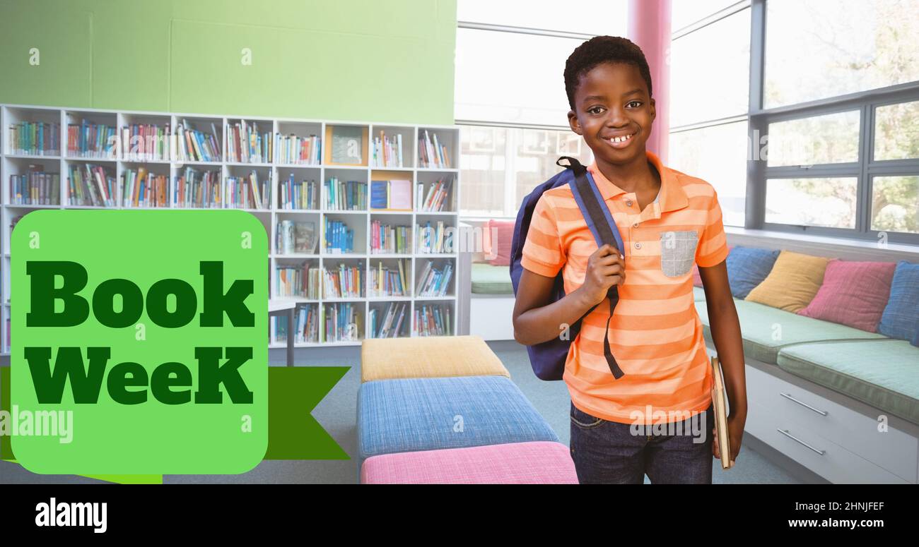 Book week text over portrait of smiling african american elementary boy ...