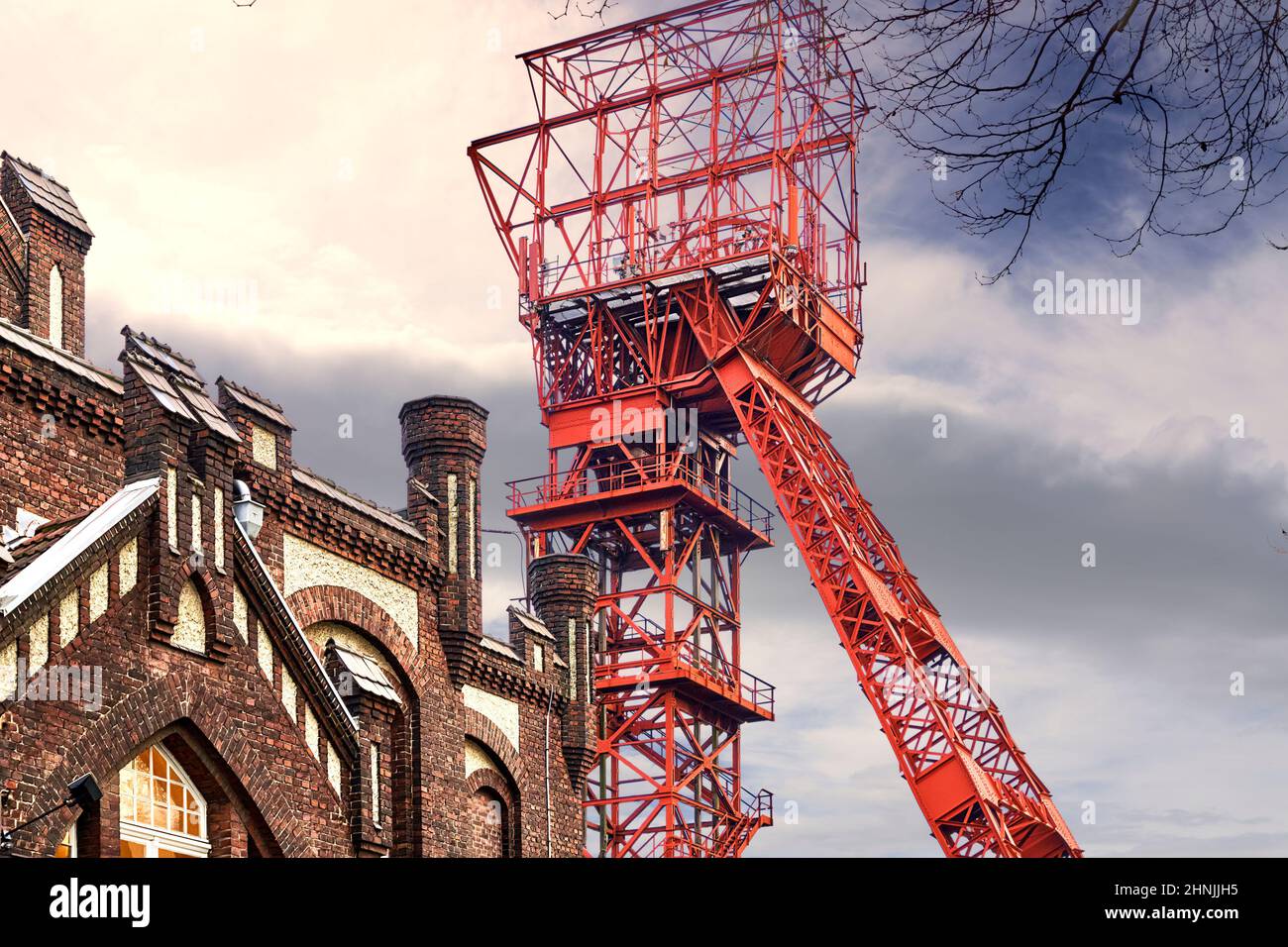 Essen, Germany, February 9, 2022: Red winding tower of the former Bonifacius colliery behind the facade of a hotel in a converted colliery building Stock Photo