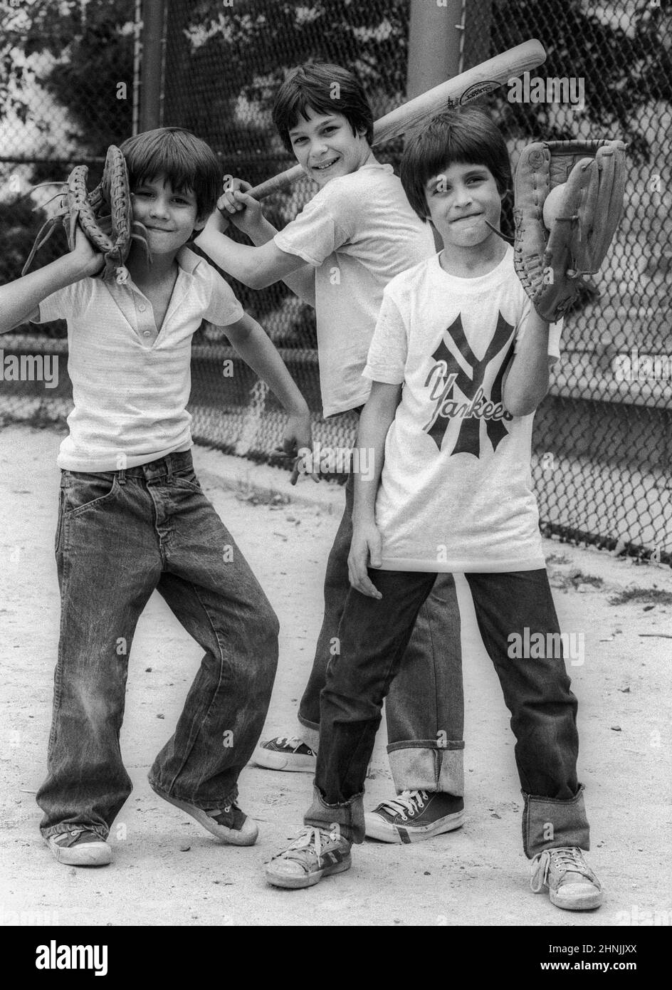 Young New York guys with baseball equipment on a sports field in