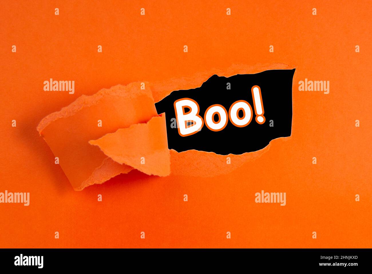 Torn hole paper orange color with copy space for text halloween Stock Photo