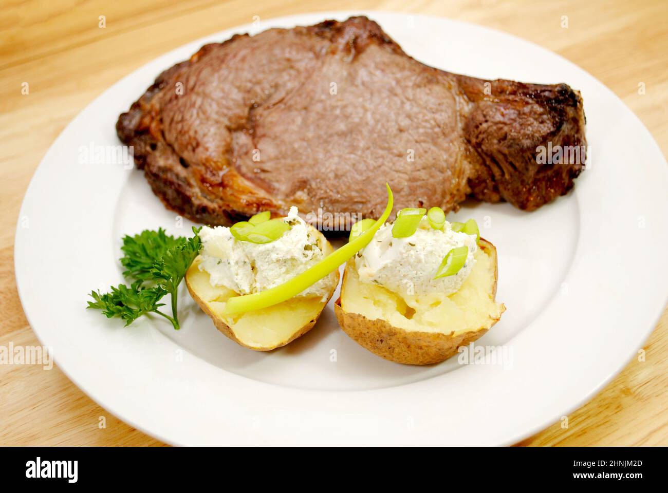 Boiled Prime Rib A Broiled Prime Rib Steak Served with Baked Potato and Scallions Stock ...