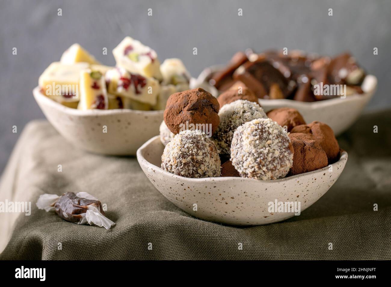 Variety of homemade toffee chocolate almond nuts candy, dark chocolate truffle, white chocolate