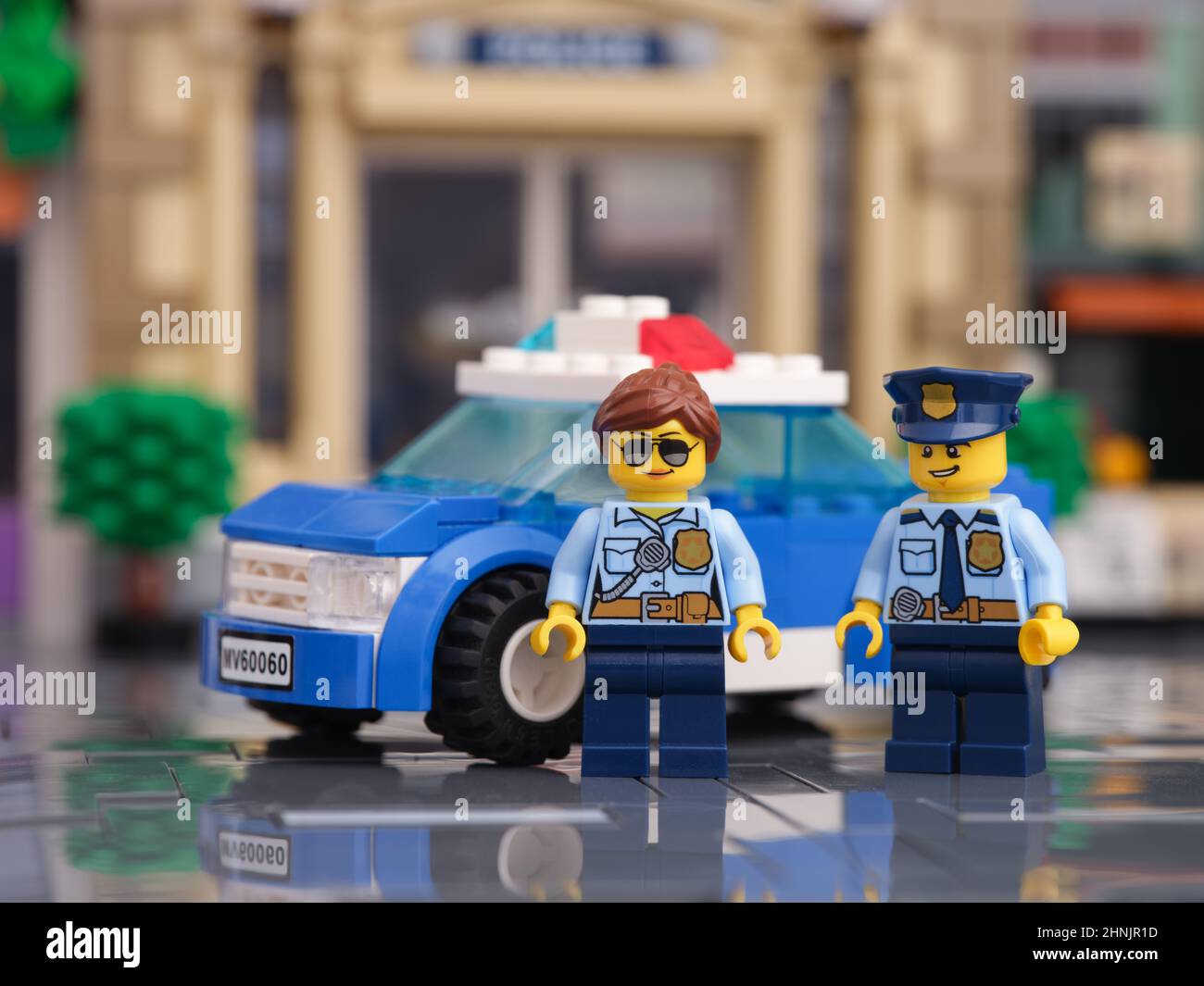 Tambov, Russian Federation - February 16, 2022 Two Lego police officer minifigures standing in front of their police car. Stock Photo