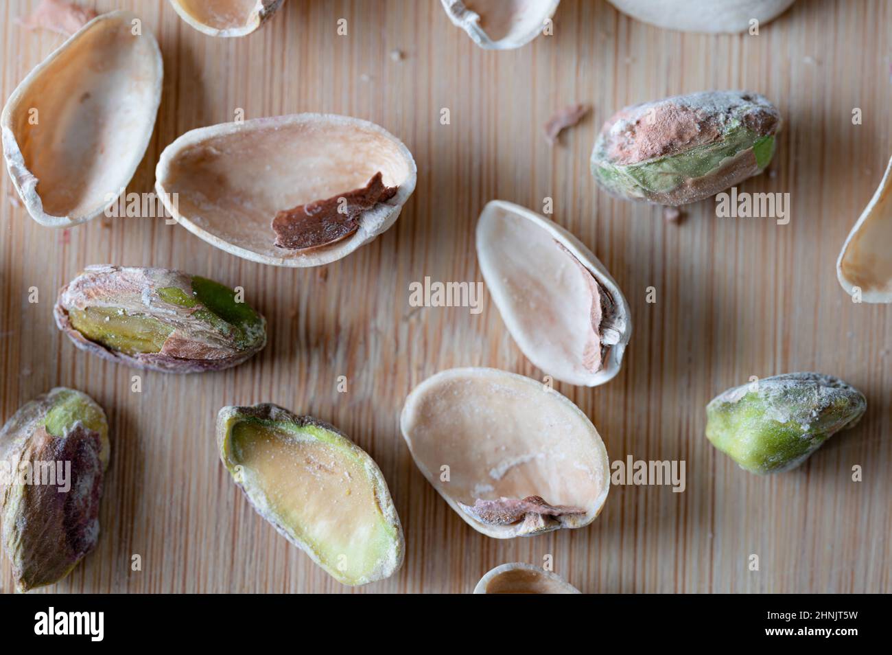 Pistachio nuts and shells on wood background Stock Photo