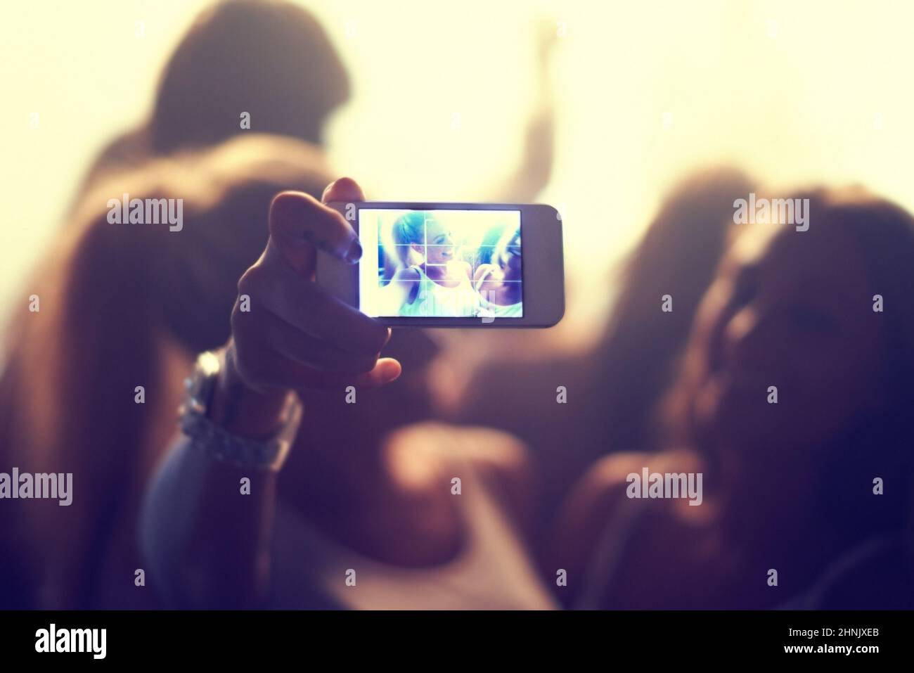Well never forget this night. Shot of a fan filming a concert on their camera. Stock Photo