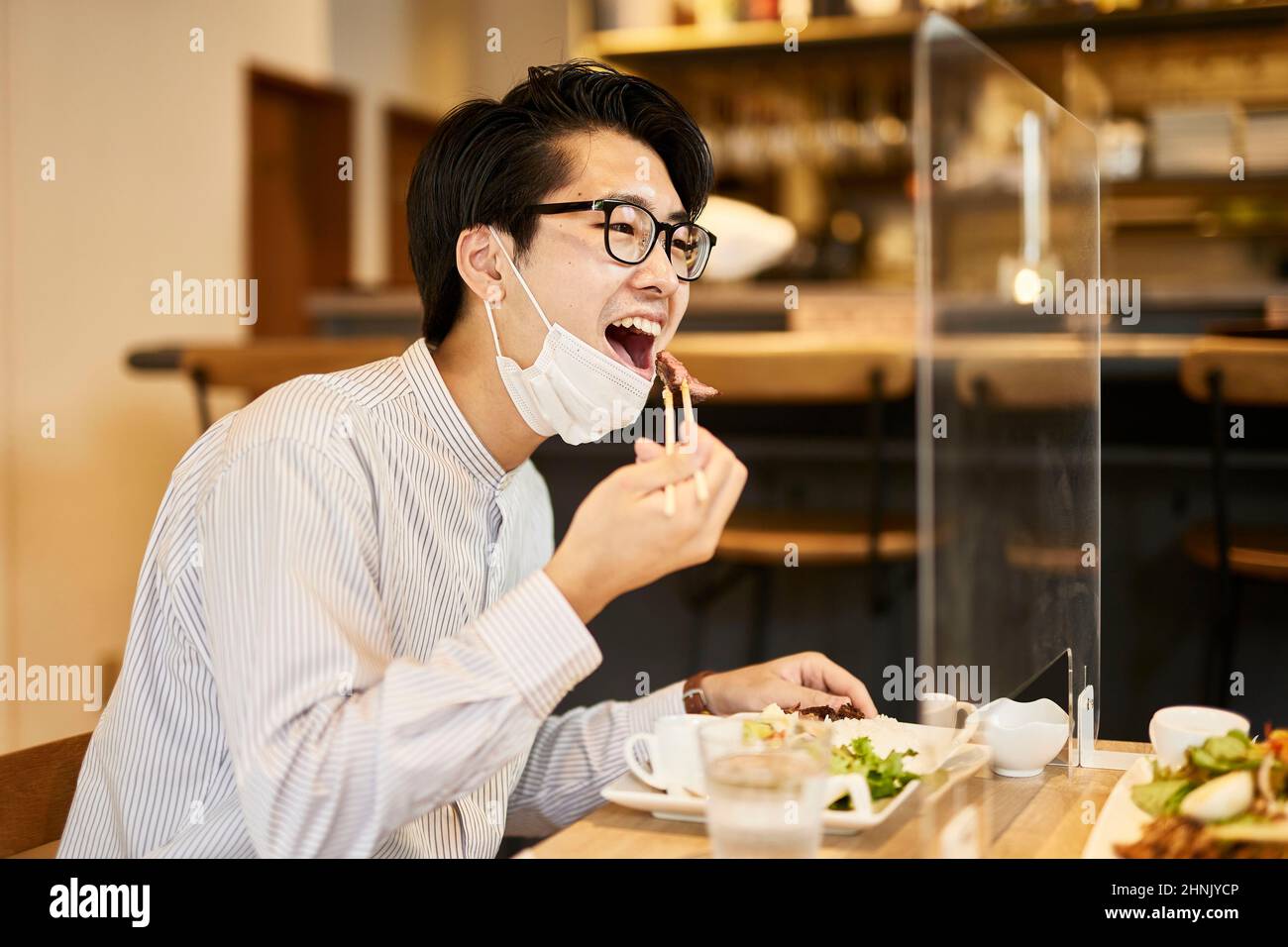 Japanese Man Eating Over The Partition Stock Photo Alamy