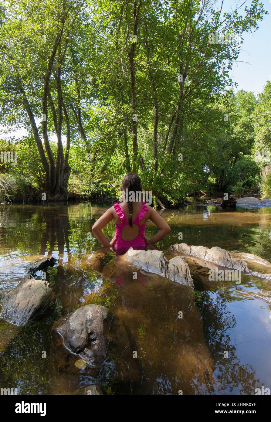 Child girl discovering Gevora river, Extremadura, Spain Stock Photo