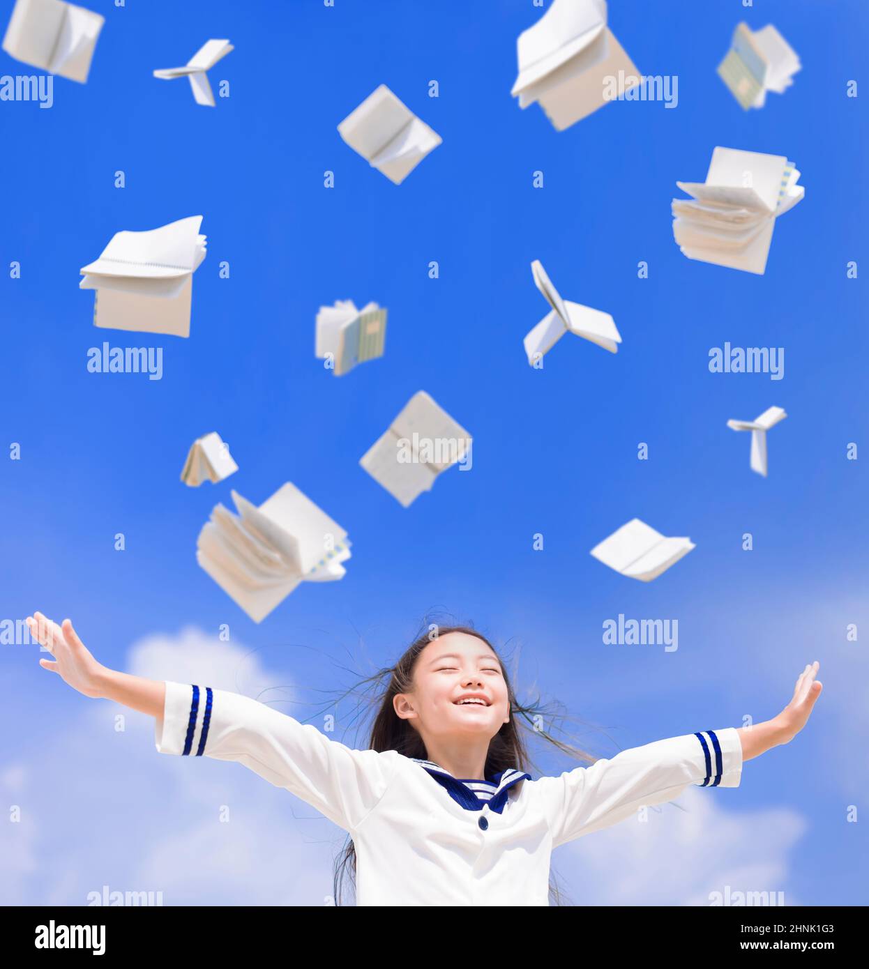 Excited student girl throwing books fly in the air Stock Photo Alamy