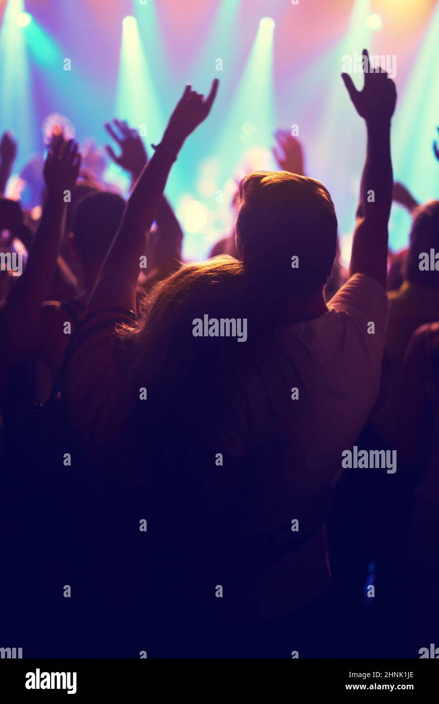 A crowd of people watching a band play on stage at a nightclub. This concert was created for the sole purpose of this photo shoot, featuring 300 Stock Photo