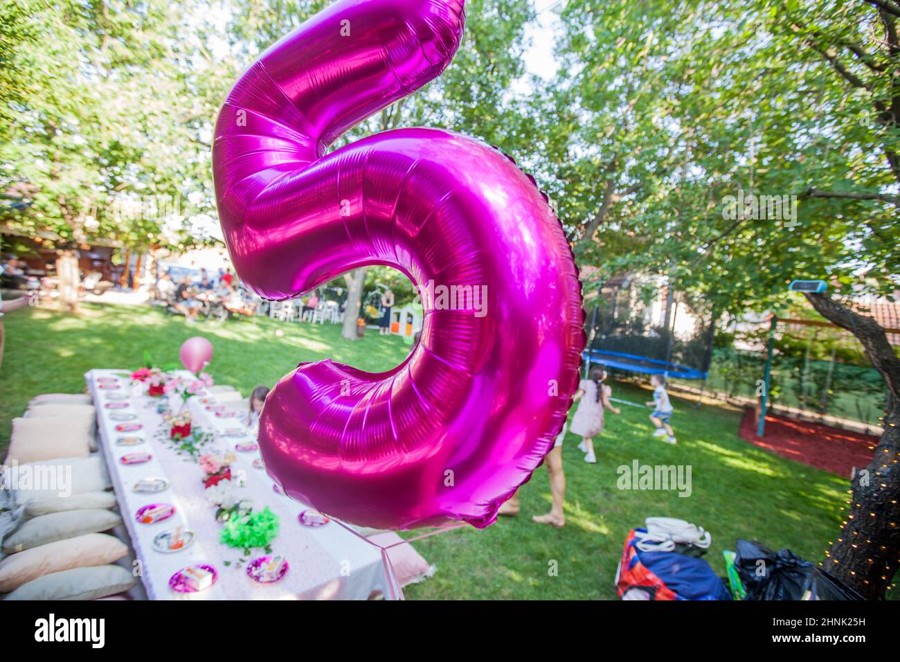 Happy Birthday decoration. Birthday Balloon At Summer Garden Party. Number Five Balloon Stock Photo