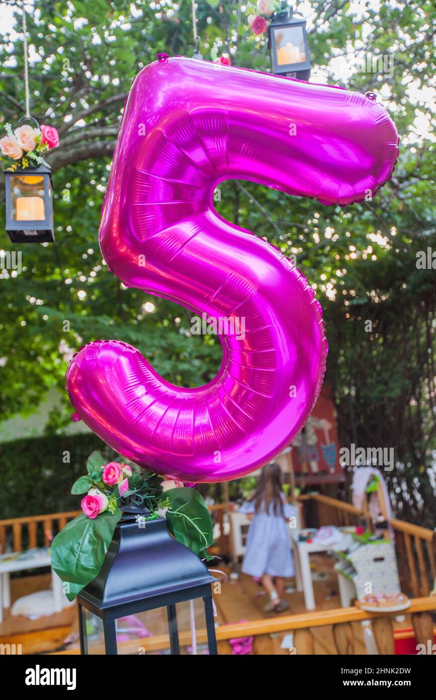 Happy Birthday decoration. Birthday Balloon At Summer Garden Party. Number Five Balloon Stock Photo