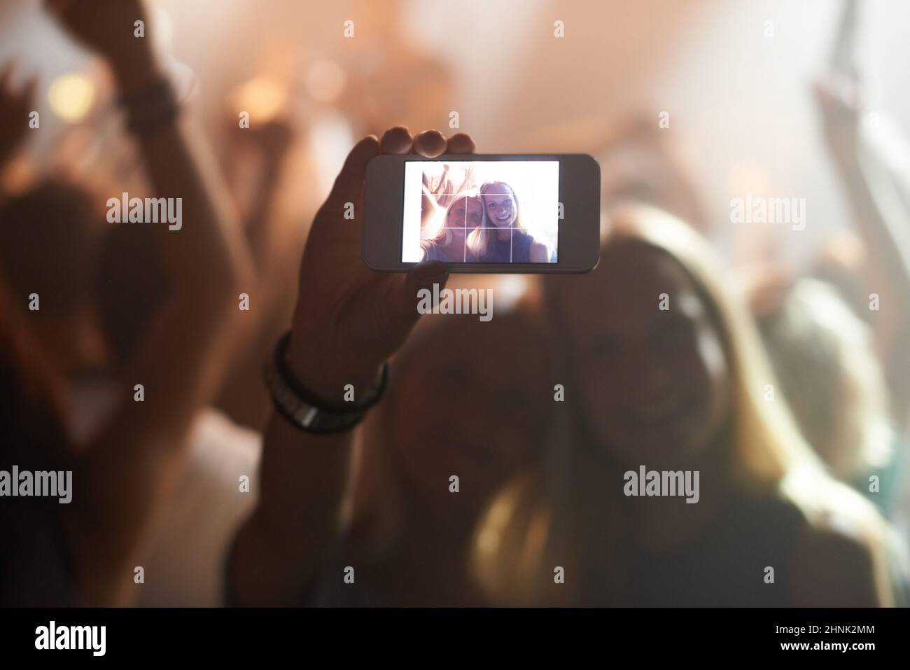 No cameras during the concert. Shot of a fan filming a concert on their camera. Stock Photo