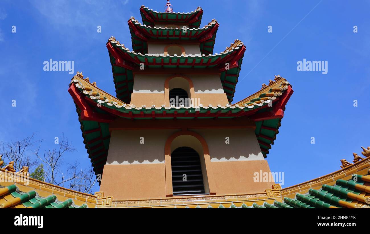 Upward forced perspective Asian pagoda blue sky background Stock Photo