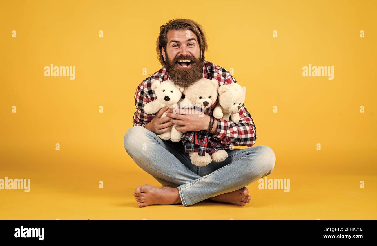 male feel playful with bear. brutal mature hipster man play with toy. happy birthday. being in good mood. happy valentines day. cheerful bearded man Stock Photo