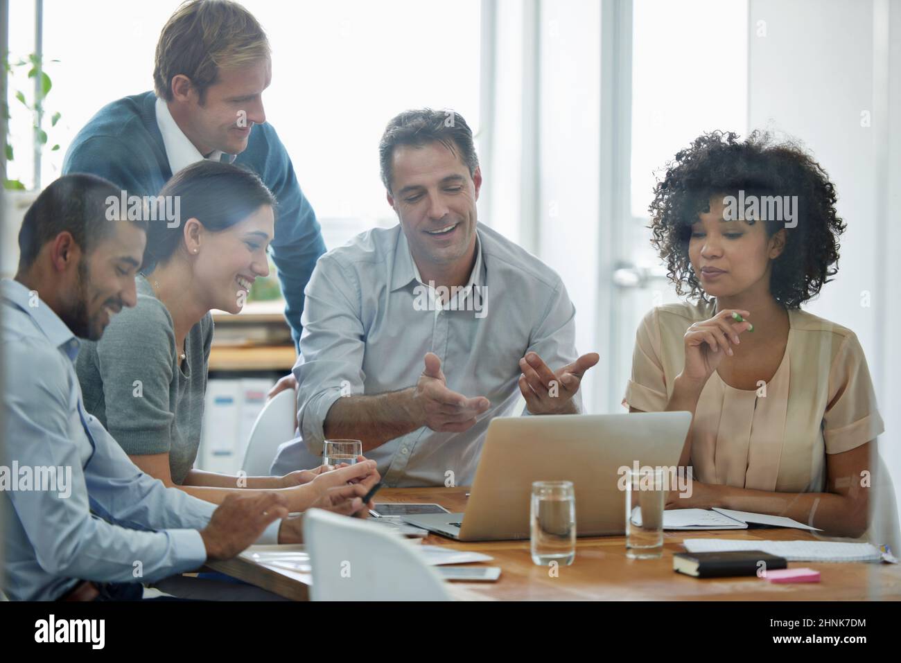 Brainstorming doesnt have to be boring. Shot of a group of professionals using wireless technology during a meeting. Stock Photo