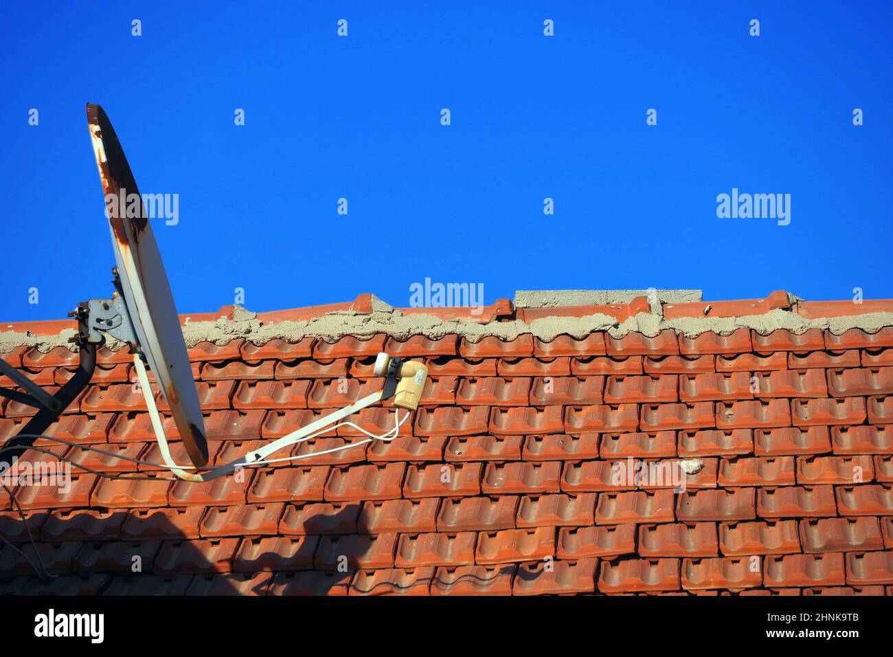 old satellite dish on the roof of a building Stock Photo Alamy