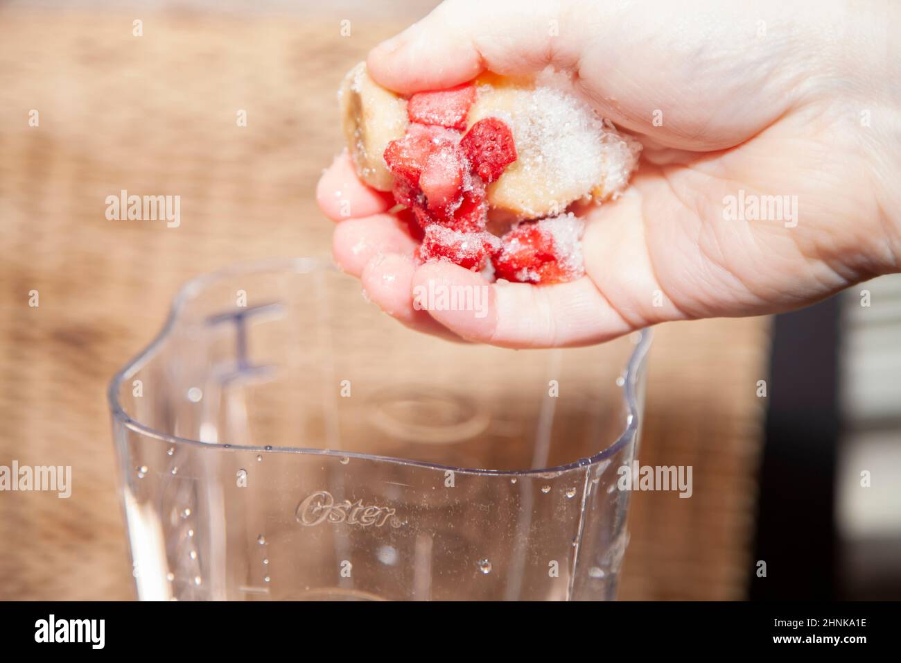 Dropping Frozen Fruit into a Blender Stock Photo Alamy